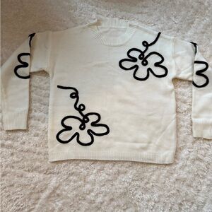 Women’s cream colored sweater w/black flowers. NWOT, Sz M